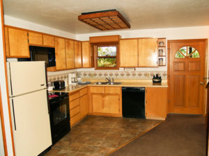 Photo of kitchen with refrigerator, stove, microwave, dishwasher and cabinets